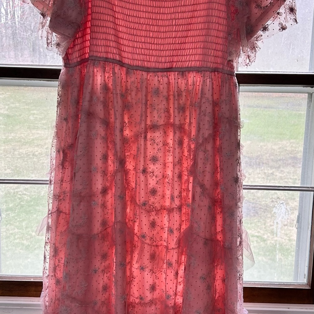 Pink Dress with flower and ruffle details.